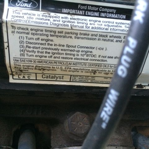 1988 Ford Bronco - Close-up of an engine information sticker, including details about oil type and emissions compliance.