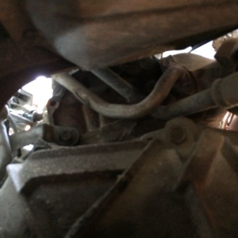 1988 Ford Bronco - Undercarriage view shows a section of the exhaust system and associated parts.