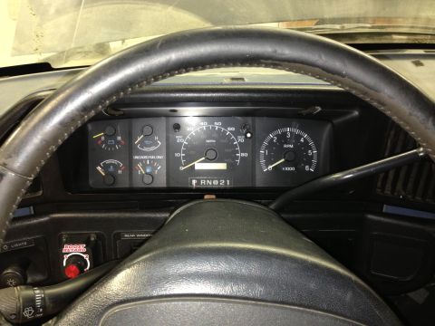 1988 Ford Bronco - The interior view of a 1988 Ford Bronco shows the dashboard gauges, including the speedometer and tachometer, and the steering wheel.