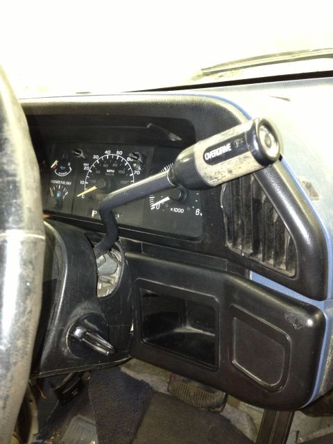 1988 Ford Bronco - Close-up of a vehicle's interior, focusing on the dashboard and shifter column.