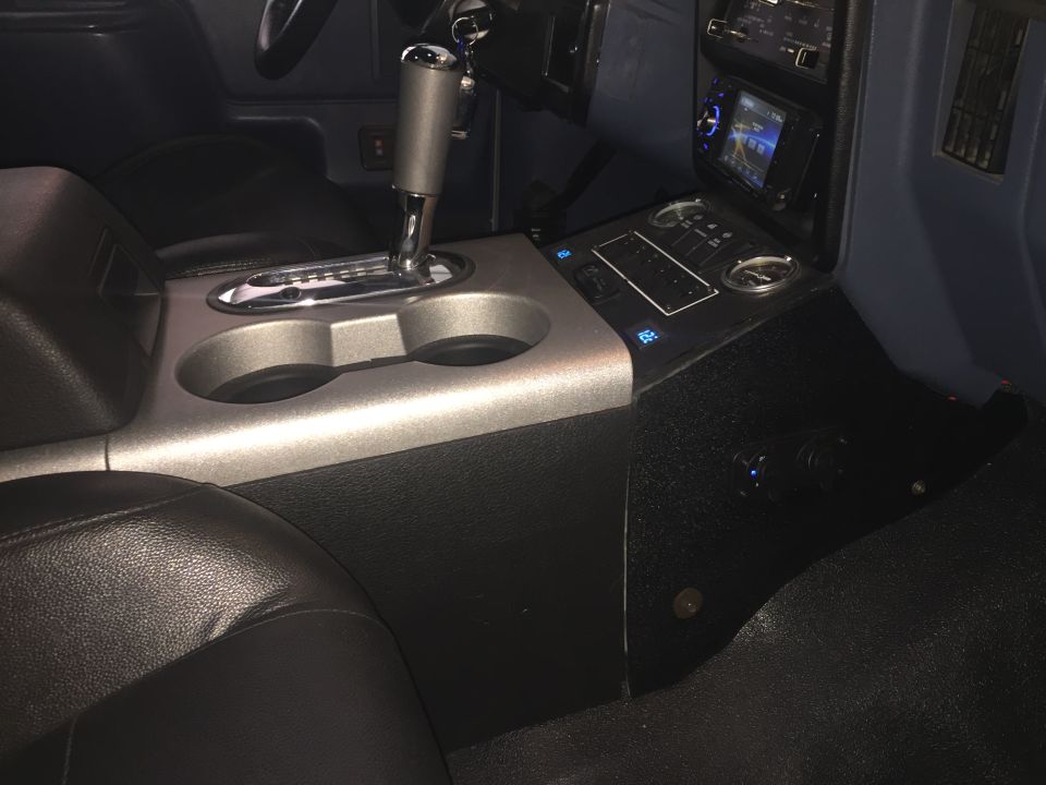 Center console with automatic shifter, cup holders, and aftermarket infotainment screen
