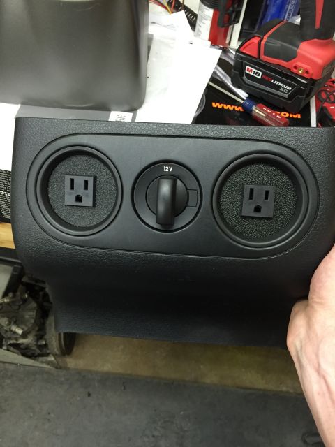 1988 Ford Bronco - Center console trim piece with a 12V socket and two AC outlets, likely an aftermarket modification.
