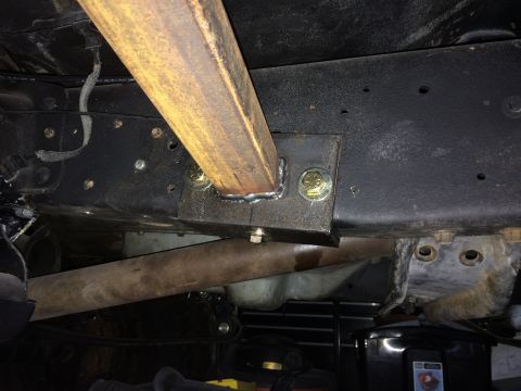 1988 Ford Bronco - Custom rock slider welded to the frame of a vehicle, likely for off-road use.