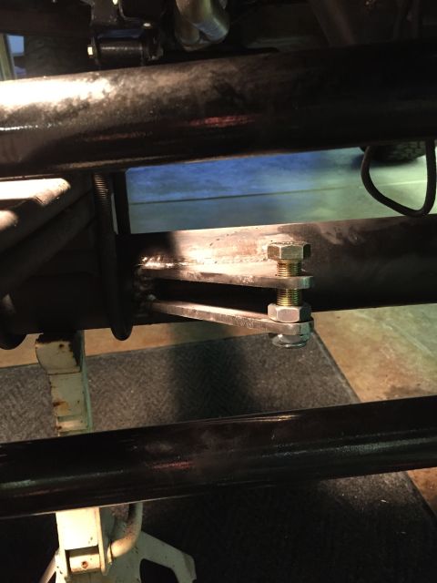 1988 Ford Bronco - A close-up view shows a custom metal bracket welded to a large diameter tube, secured by a bolt and nut assembly. The bracket appears to be…