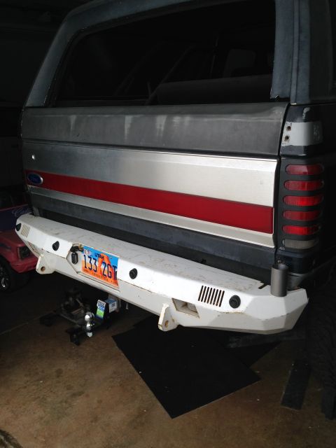 1988 Ford Bronco - The rear of a Ford Bronco with a custom white bumper and a Utah license plate is shown. The vehicle has a silver and red stripe along the r…