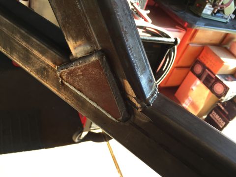 1988 Ford Bronco - A close-up view shows a welded metal joint on a vehicle frame. The metal appears to be steel and has some rust and discoloration from weldi…