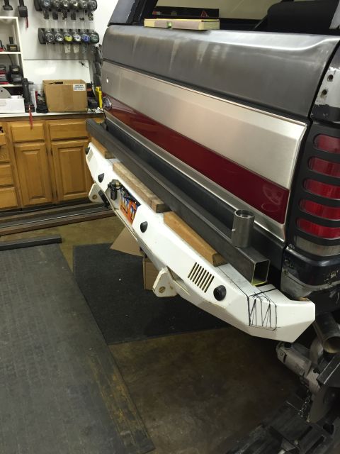 1988 Ford Bronco - A white aftermarket bumper is being fabricated and attached to the rear of a Ford Bronco. Metal tubing and wood blocks are used to support…