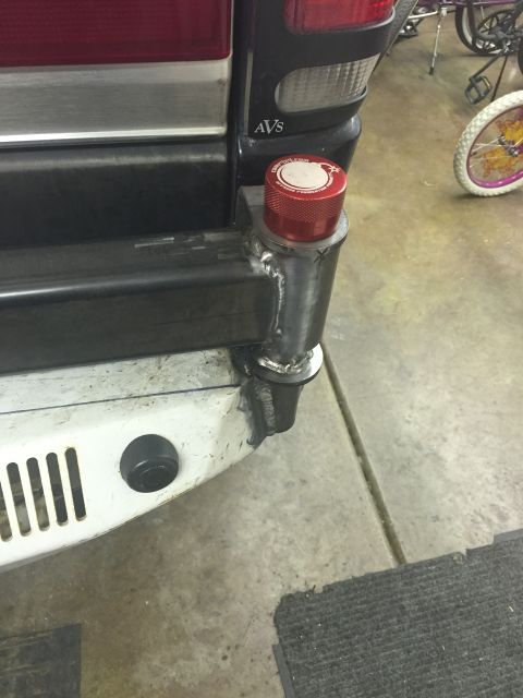 1988 Ford Bronco - A close-up view of a custom rear bumper attachment on a vehicle, featuring a red cap with text that reads "COMPUXXXI.COM" and "BEYOND FABRI…