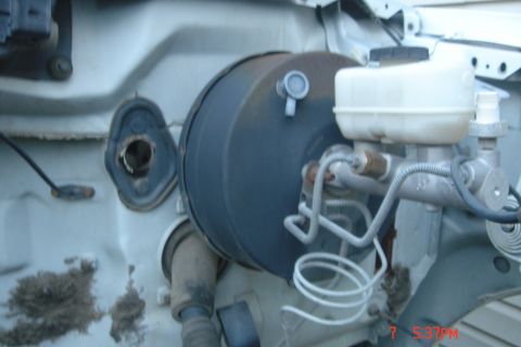 1988 Ford Bronco - This image shows the brake booster and master cylinder assembly of a vehicle, likely from the driver's side firewall area. The brake booste…