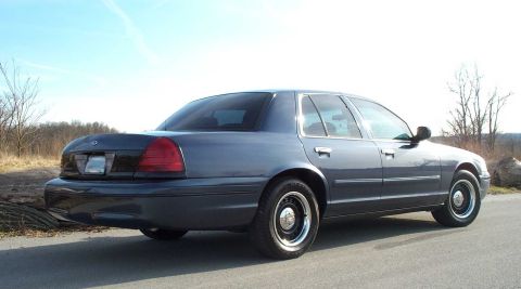 1998 Ford Crown Victoria - Rear three-quarter view of a 1998 Ford Crown Victoria sedan on a clear day.
