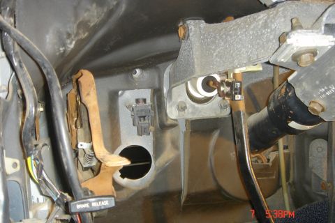1988 Ford Bronco - This is a close-up view of the brake and clutch pedal assembly inside a vehicle, showing various components and wiring.