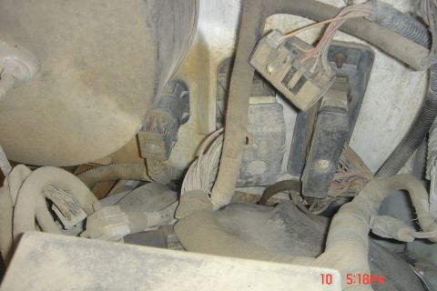 1988 Ford Bronco - This image shows a close-up view of various electrical connectors and wiring harnesses, likely from the engine bay of a vehicle. The compon…
