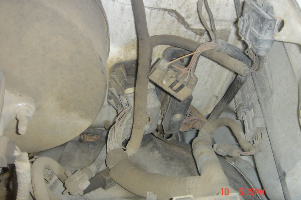 Engine bay of a 1988 Ford Bronco with dusty electrical components and wiring.
