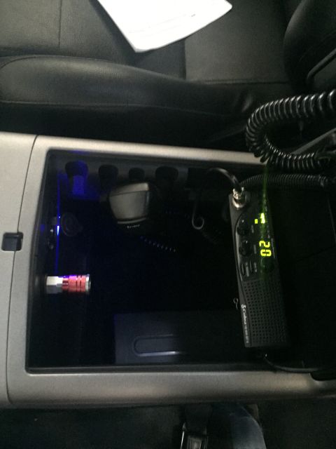 1988 Ford Bronco - A CB radio with a digital display showing "02" is mounted in the center console of a vehicle. A coiled cord connects the radio to a microph…