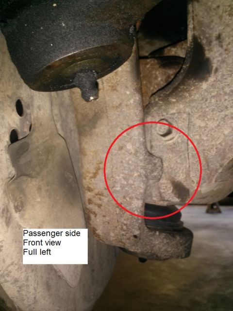 1996 Ford Bronco - This is a close-up, front view of the passenger side suspension of a 1996 Ford Bronco. A red circle highlights a bolt and bracket on the su…