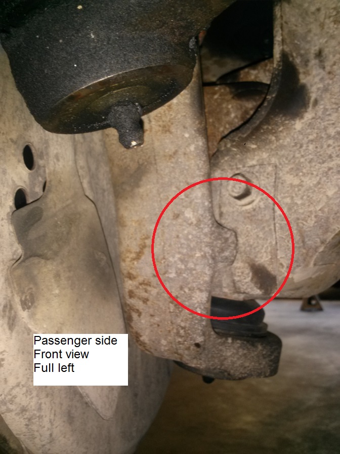1996 Ford Bronco passenger side front suspension with a red circle around a bolt and bracket.
