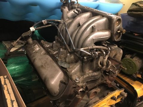 1993 Ford Bronco - A close-up view of a Ford V8 engine, likely from the 1990s, with its intake manifold and valve covers visible. The engine appears to be in…