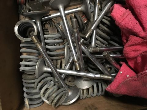 1993 Ford Bronco - A close-up, overhead view of a pile of engine valves and springs, some of which are resting on a red cloth.