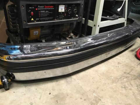 1993 Ford Bronco - A chrome and black bumper is shown in the foreground, with a portable generator visible behind it. The bumper appears to be from a truck or…
