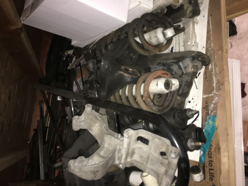 Suspension parts for a 1993 Ford Bronco, including shocks, springs, and control arms.