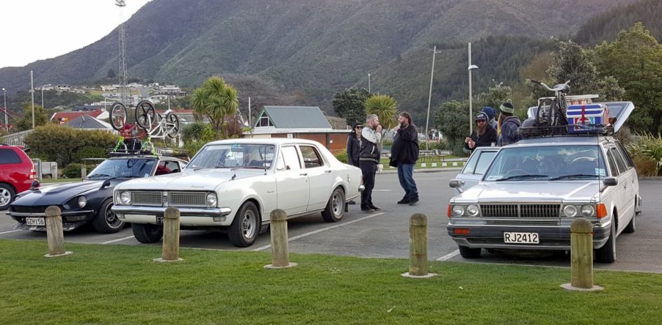 White 1960s sedan parked next to other vehicles.