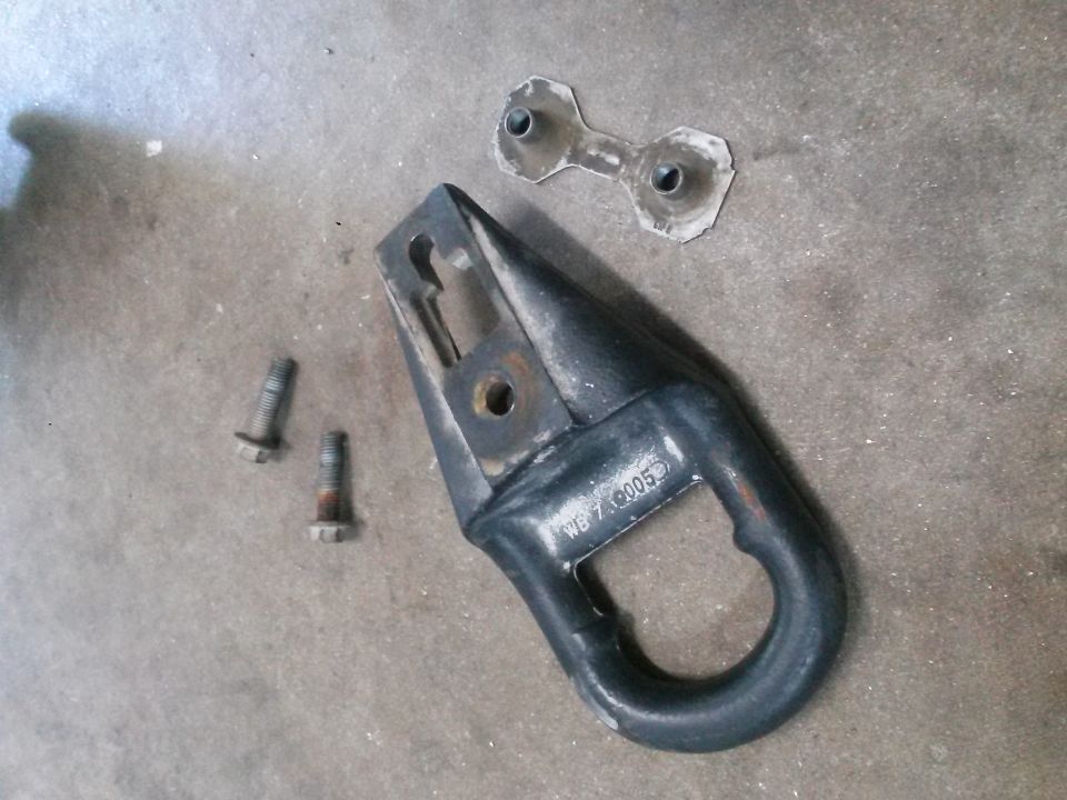 Black tow hook assembly with bolts and bracket on concrete