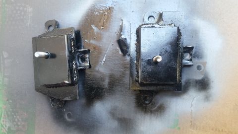 1979 Ford Bronco - Two black engine mounts with threaded studs are shown, one on the left and one on the right. They appear to have been recently painted and…