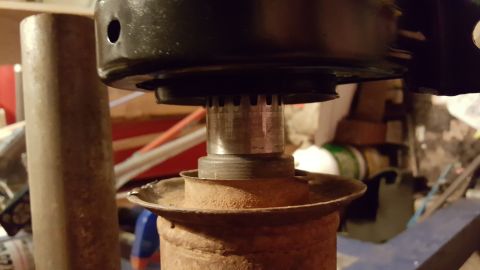 1973 Ford F-100 - A close-up view shows the splined shaft of a vehicle's driveshaft connecting to a yoke. The surrounding components appear to be rusty metal…