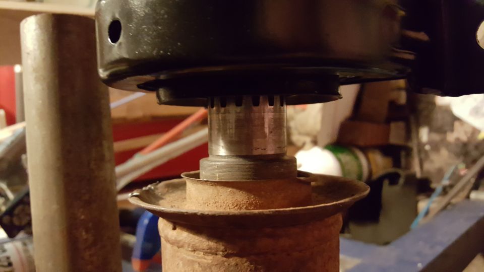 Splined driveshaft connecting to a yoke, with rusty metal parts.