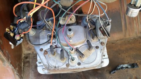 1973 Ford Bronco - A complex web of wires connects to the dashboard gauges and a switch in this vintage vehicle.