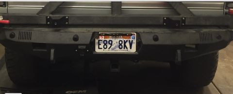 1988 Ford Bronco - The rear bumper of a vehicle is shown, a license plate and tow hitch.