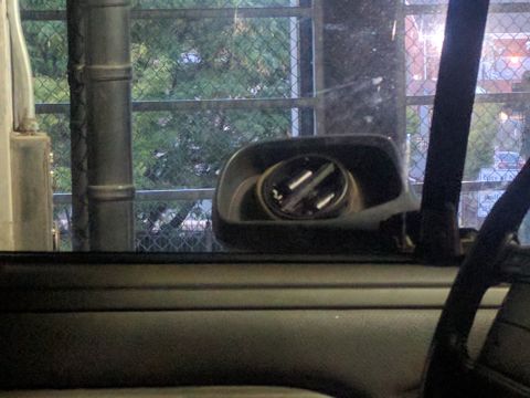 1995 Ford Bronco - View from inside a vehicle, showing the door panel and side mirror.