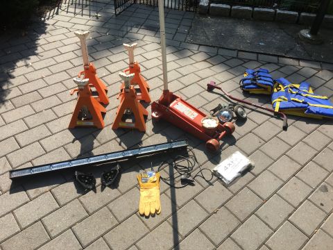 1979 Ford Bronco - Various automotive tools and safety gear are arranged on a brick patio, ready for use.