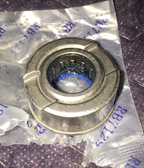 1978 Ford Bronco - A clutch release bearing, part number RB71125, is shown with blue grease inside its rollers and packaging.