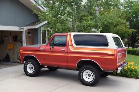 1978 Ford Bronco - This 1978 Ford Bronco is parked in front of a house with a garage.
