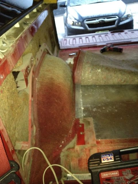 1978 Ford Bronco - Interior view of a red vehicle, with another car seen through the open rear.