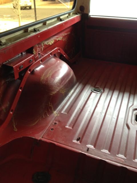 1978 Ford Bronco - The interior cargo area of a 1978 Ford Bronco reveals its ribbed floor and rear wheel wells.