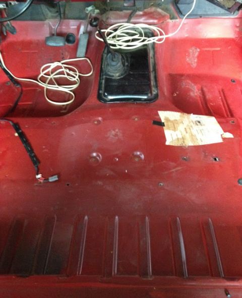 1978 Ford Bronco - Vehicle interior floor shows exposed wiring and the transmission tunnel, suggesting a project or restoration.