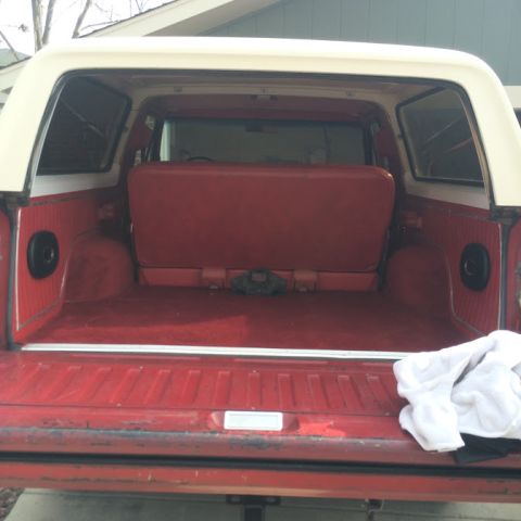 1978 Ford Bronco - The rear cargo area of a 1978 Ford Bronco shows its red carpet and seating.