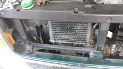 1996 Ford Bronco - this is passenger side cutout of the core support where the hoses from the cooler and the engine are going through to meet at the filter