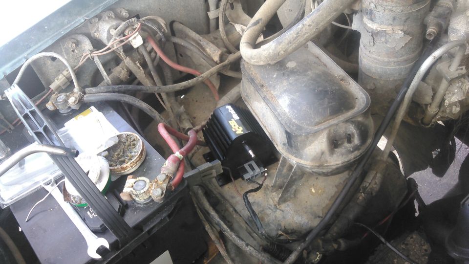 due to the size of the coil, i decided the best place to mount it would be between the battery tray and the vacuum reservoir on the wheel well. it is still close enough to the distributor that i can run a normal plug wire to it. its easy to access. i may change the location in the future aswell.

i extended the stock wiring to reach around the back of the engine, back forward  toward the thermostat and over to the coil