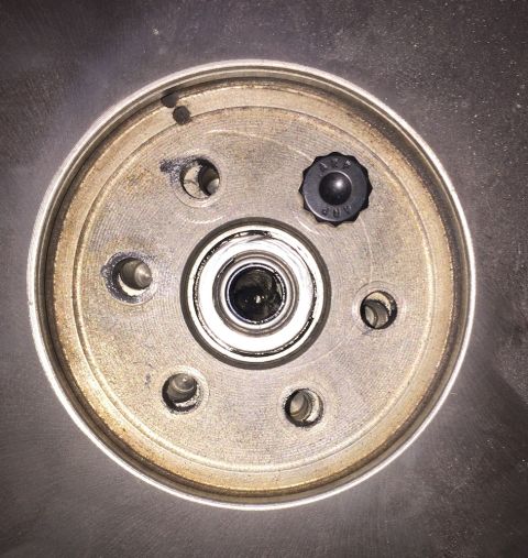 1978 Ford Bronco - This is a close-up view of a clock's internal mechanism, showing gears and an adjustment knob.