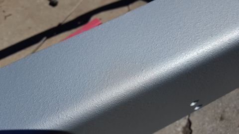 1994 Ford Bronco - A close-up view of a painted metal part, possibly a frame or bumper component.