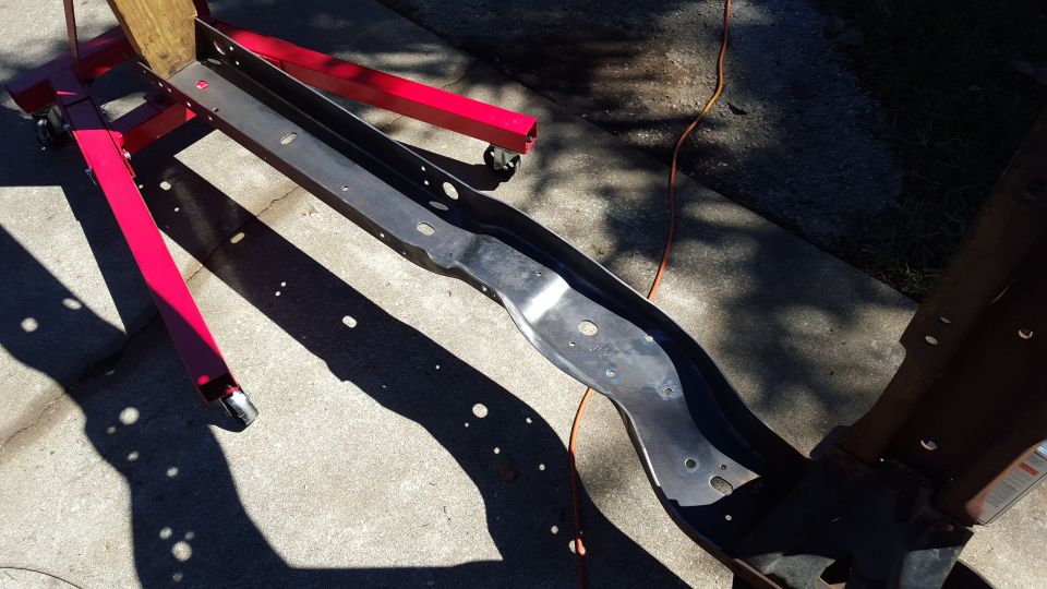 Vehicle frame section on red engine stand outdoors