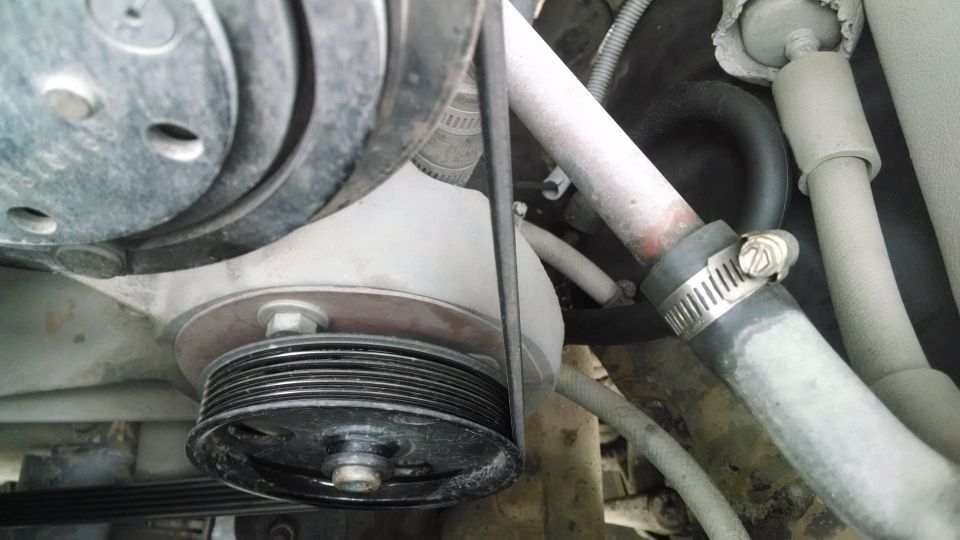 Engine belt and pulleys with hoses and clamps