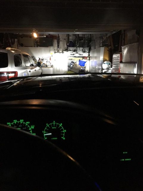 1996 Ford Bronco - The photo shows the interior of a vehicle parked in a garage with another vehicle visible outside.