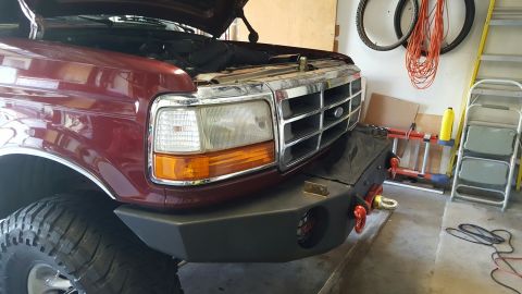 1996 Ford Bronco - Front view of a 1996 Ford Bronco with its hood up, an aftermarket bumper.