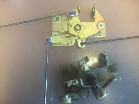 1979 Ford Bronco - Two door latch mechanisms are shown, one appearing newer and the other showing signs of wear.