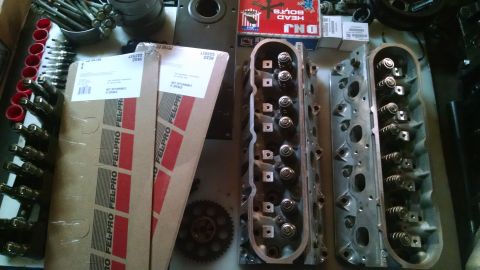 1985 Jeep CJ7 - Engine cylinder heads and Fel-Pro gasket boxes are laid out, along with various engine components and hardware.
