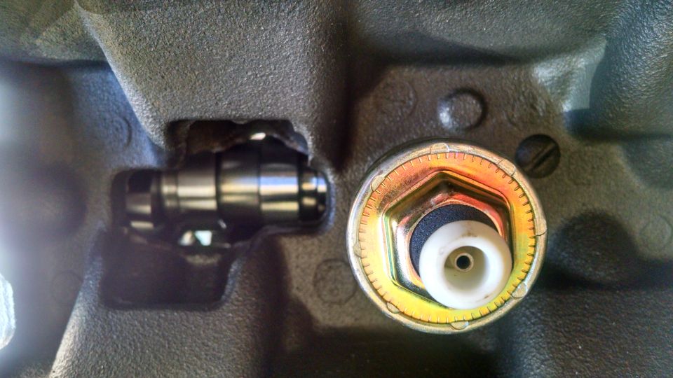 Close-up of an engine block with a sensor installed